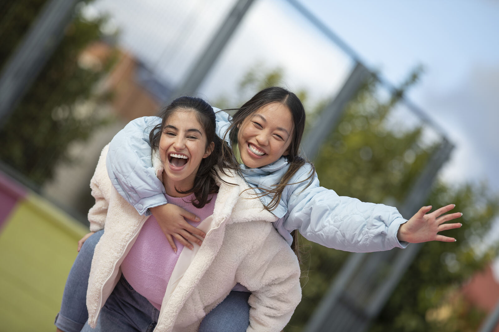 Two young people laughing together outdoors